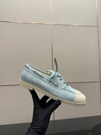 Chanel women's light-blue sneaker held up, lace-up front and stitching detail