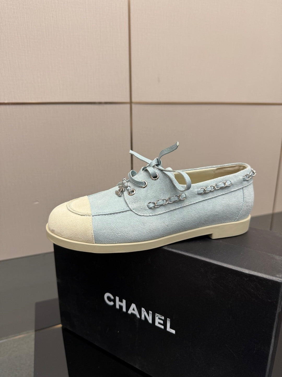 Chanel women's light-blue sneakers pair, side profile with lace-up detail