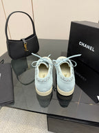 Chanel women's light-blue sneakers, heel and tongue view with lace-up detail