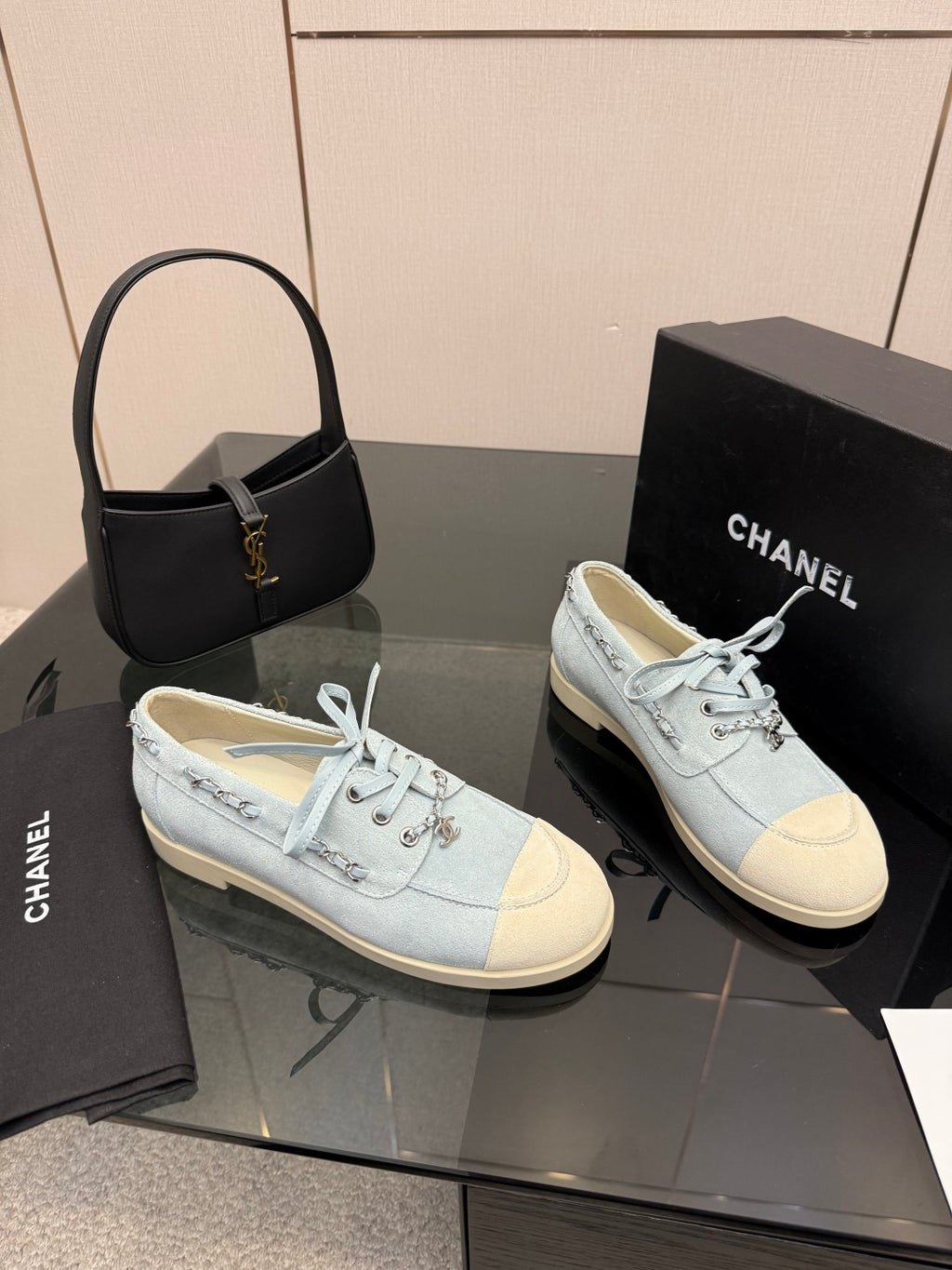 Chanel women's light-blue sneakers pair on display, lace-up fronts visible
