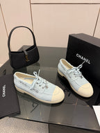 Chanel women's light-blue sneakers pair on display, lace-up fronts visible