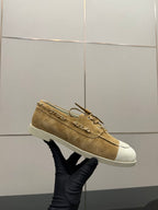 Ladies tan suede sneaker with gold chain strap detail and white rubber sole