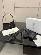 Black studded mule sandals with silver buckles and slim high heels
