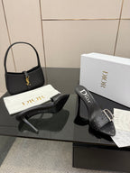 Black studded mule sandals with silver buckle straps and high heel