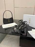 Black heeled sandals with thin straps and Dior branding on the footbed.