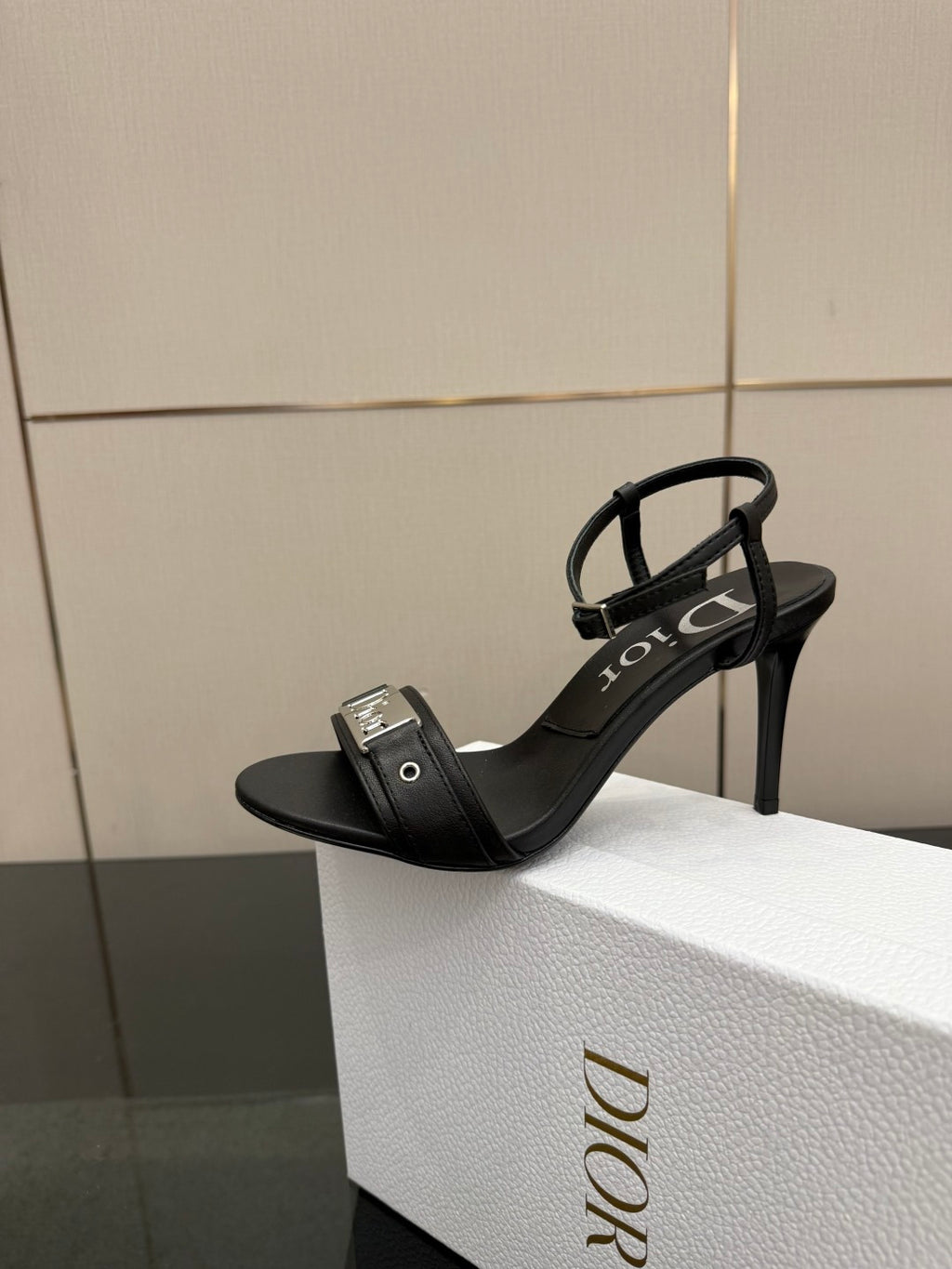 Black open-toe heeled sandal with thin ankle strap and Dior branding.