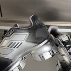Prada chunky sneaker close-up, silver side panels and black mesh, lace-up