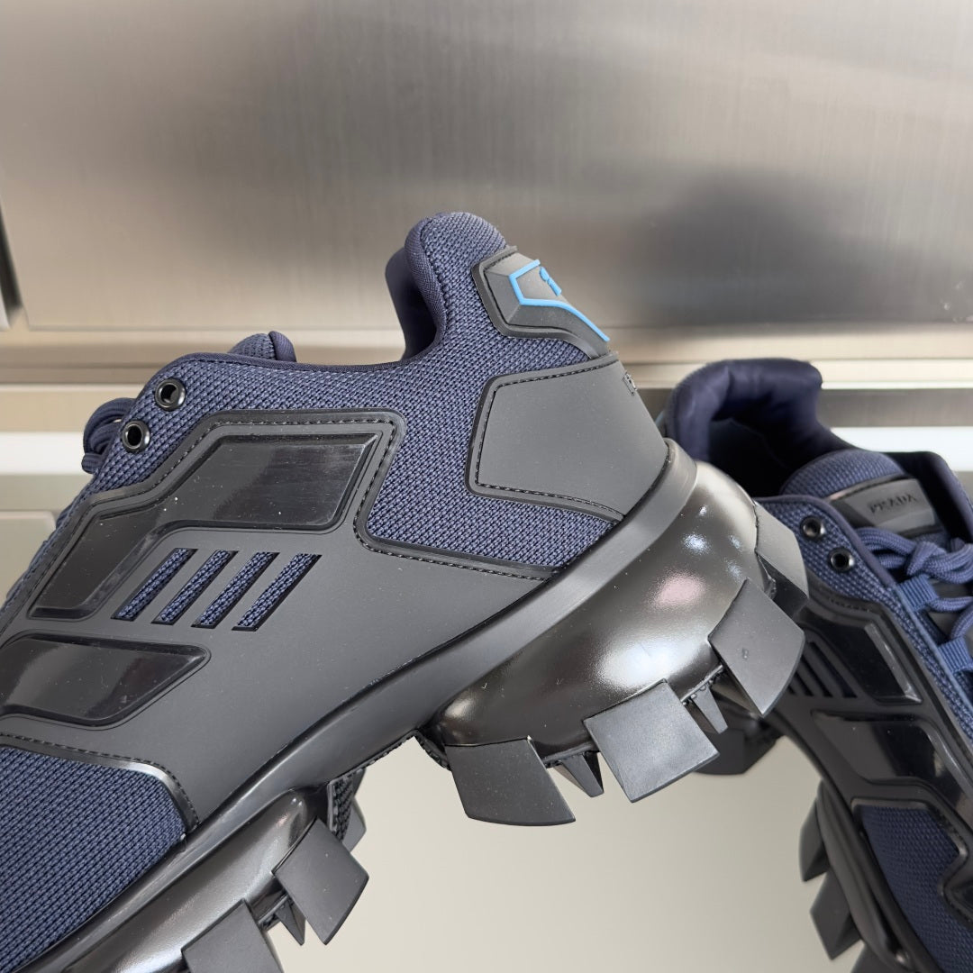 Unisex sneaker with dark blue upper, black panels, and chunky black tread.