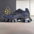 Unisex sneakers in dark blue with black rugged sole and lace-up closure.