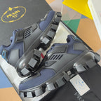 Prada unisex sneaker with dark blue mesh upper, gray panels, and chunky block tread
