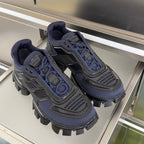 Pair of unisex sneakers in dark blue with black tread and lace-up front.
