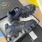 Prada unisex sneaker in dark blue with gray accents, lace-up front, and rugged platform