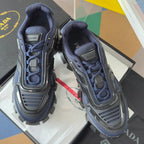 Prada unisex lace-up sneaker in dark blue with PRADA logo on tongue and silver toe guard
