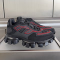 Prada unisex sneakers with dark mesh upper, red accents, and chunky lug sole