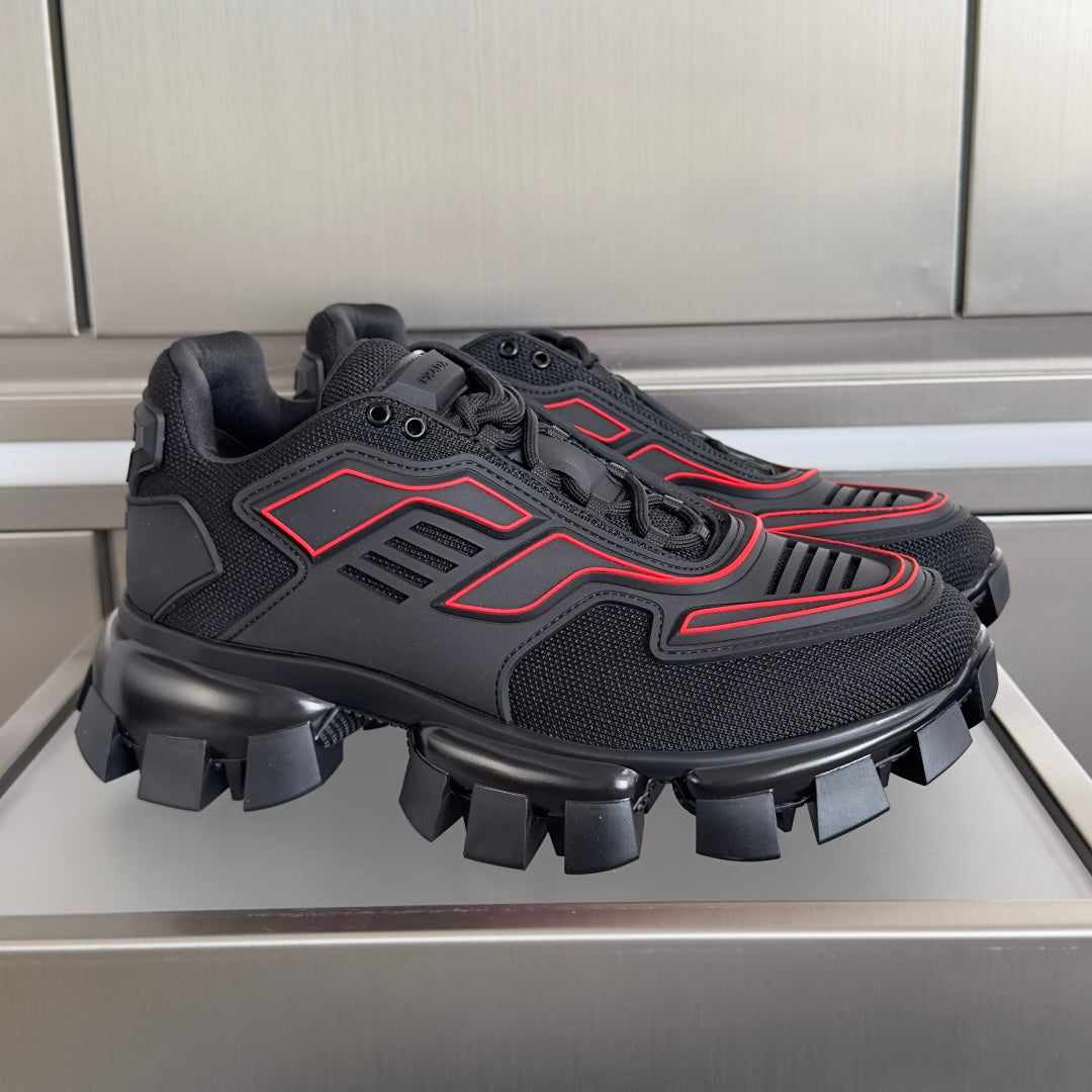 Prada unisex sneakers with dark mesh upper, red accents, and chunky lug sole