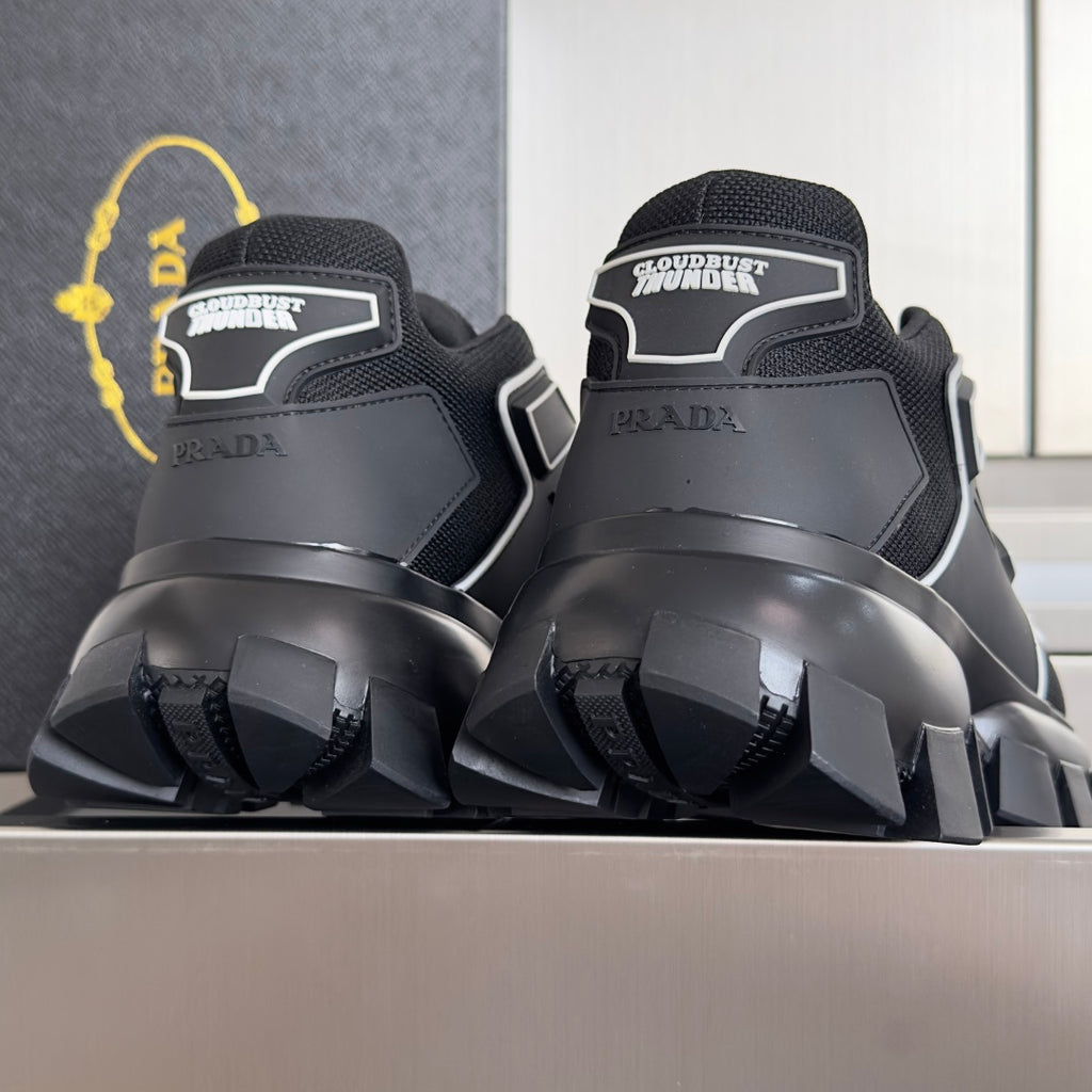 Prada unisex sneakers heel view, black back panels with white logo and thick sole