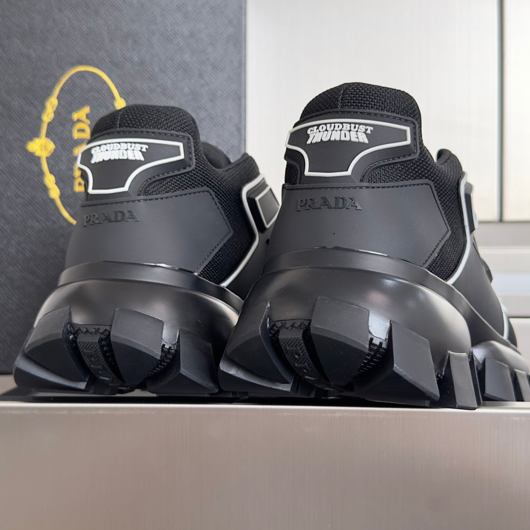Prada unisex sneakers heel view, black back panels with white logo and thick sole