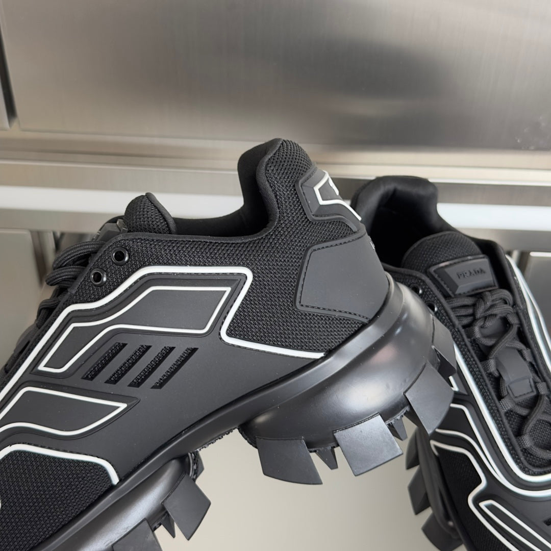 Prada unisex sneaker close-up, black upper with white trim and chunky lug heel