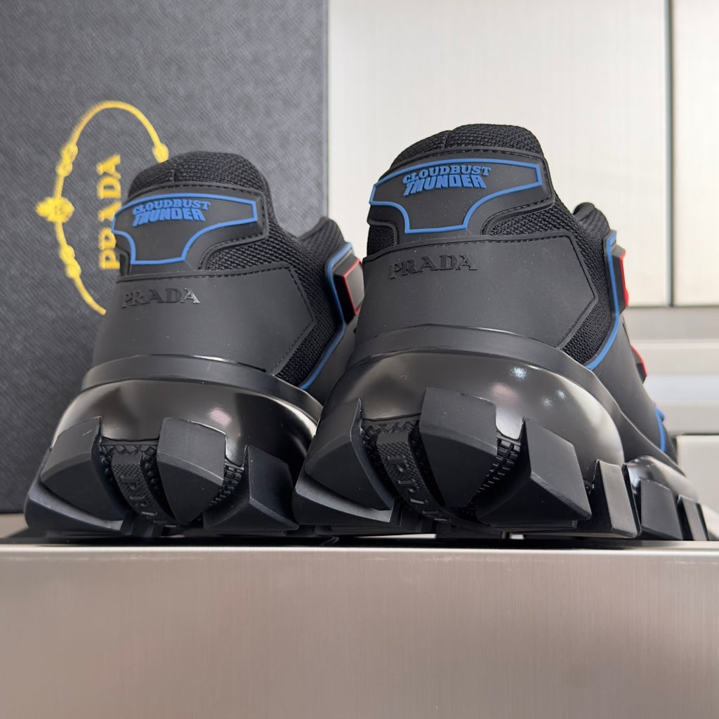 Prada unisex sneakers heel view with blue trim, padded collars, and oversized tread sole