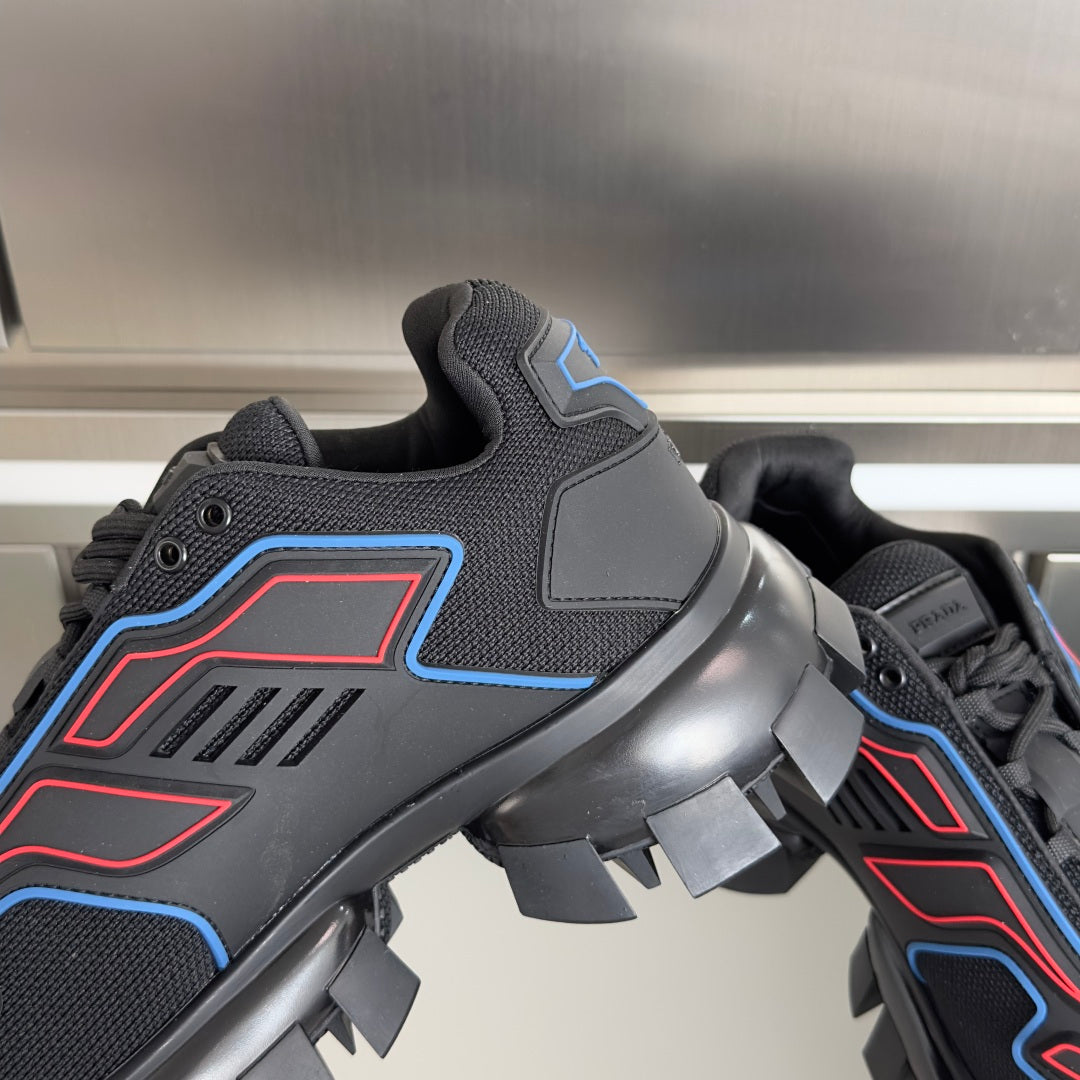 Prada unisex sneaker close-up of blue/red trim, textured upper, and molded lug outsole