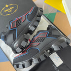Prada unisex sneakers angled view with blue and red side lines and ribbed traction sole