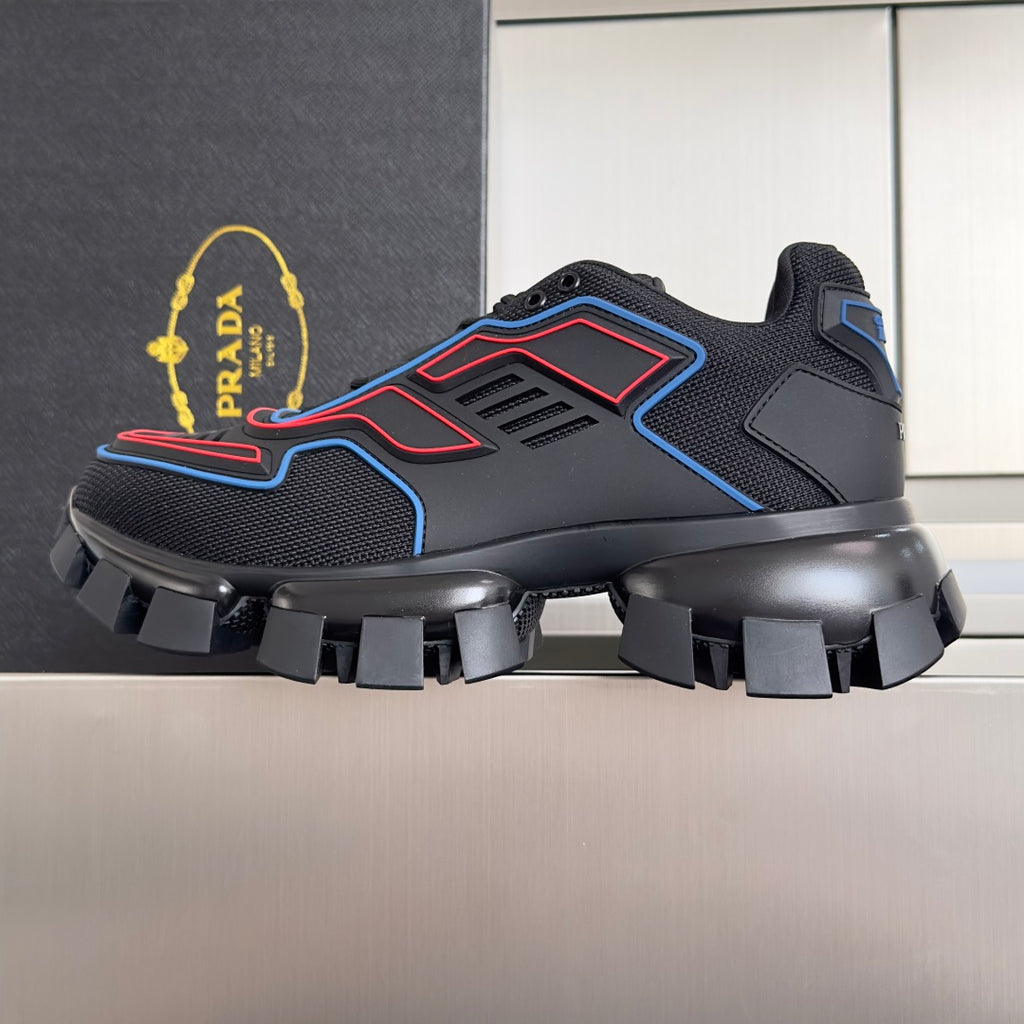 Prada unisex sneaker side view with blue and red edge accents and rugged tread sole