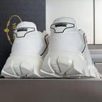 White unisex sneakers with heel pull tab and chunky tread outsole