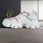 White unisex sneakers with red and black accents and thick treaded outsole