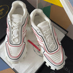 White Prada sneakers, laced front with padded collar, red/black trim, chunky sole