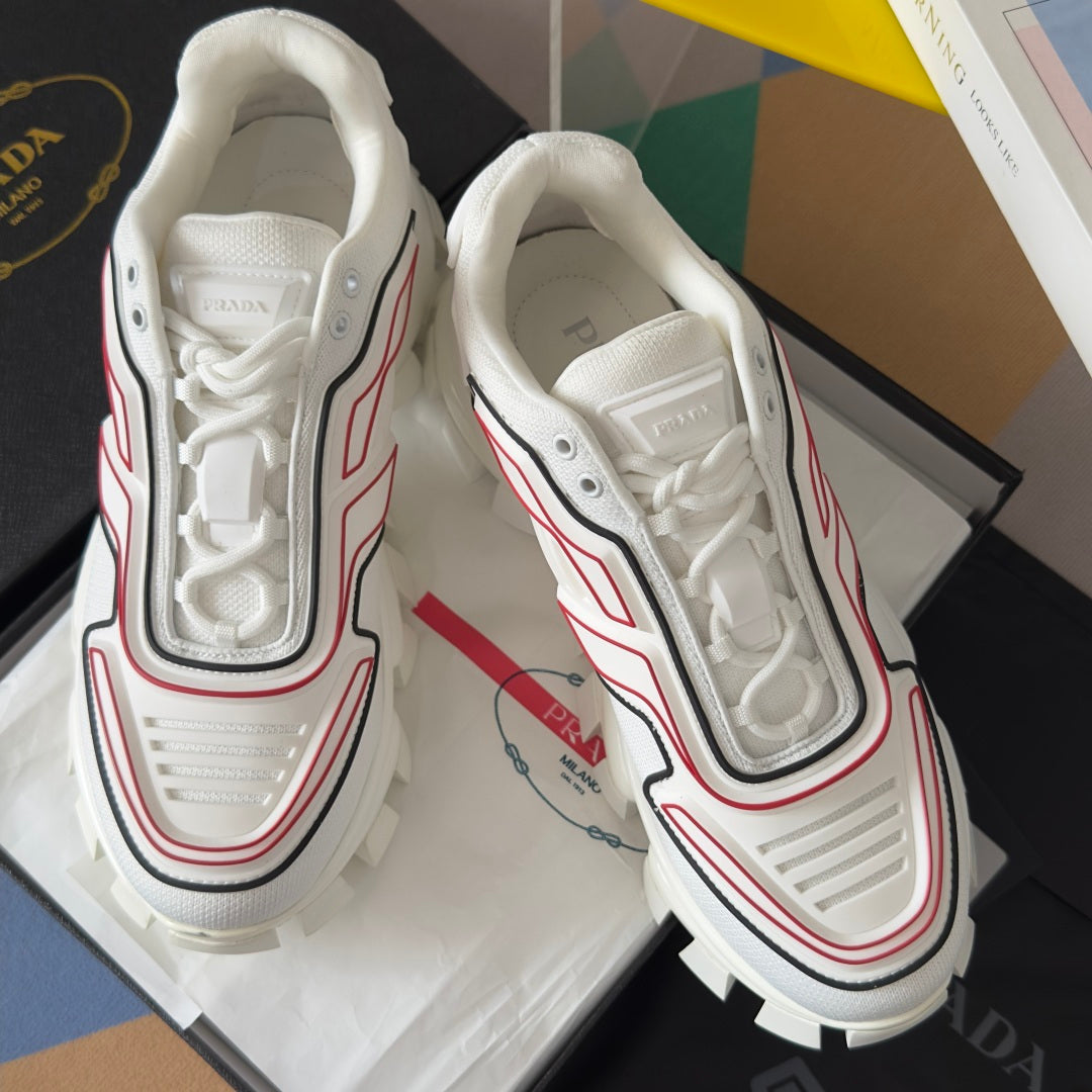 White Prada sneakers, laced front with padded collar, red/black trim, chunky sole
