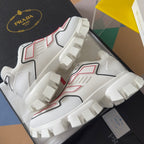 White chunky sneakers angled view, red/black panels and thick block outsole