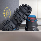 Blue and black unisex Prada sneakers with high-traction spiked outsole and heel logos