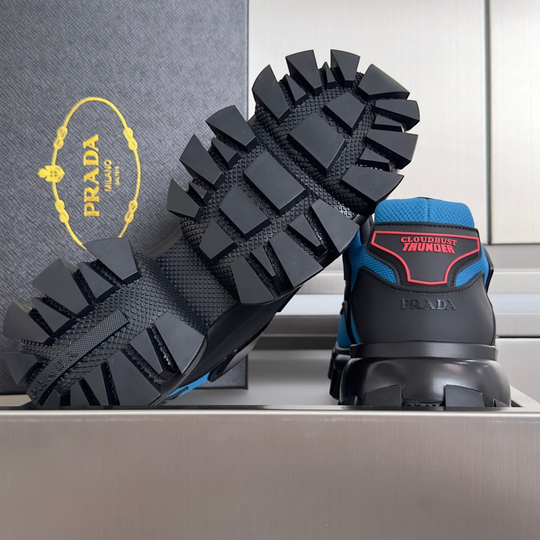 Blue and black unisex Prada sneakers with high-traction spiked outsole and heel logos