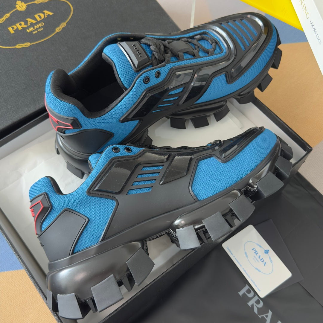 Blue and black unisex Prada sneakers with rugged lug outsole and padded ankle collar