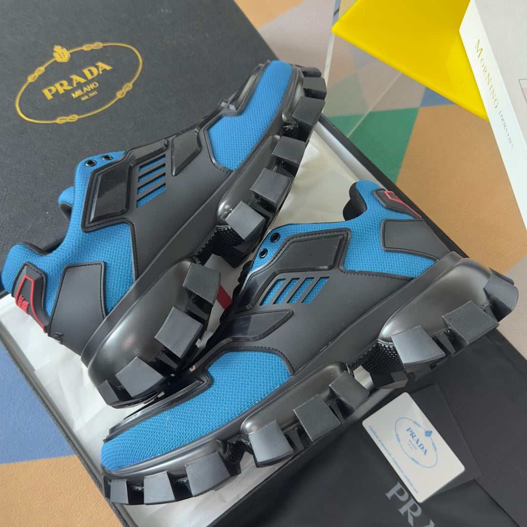 Blue and black unisex Prada sneakers with chunky rubber straps and lug sole