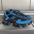 Blue and black unisex Prada sneakers with chunky tread and lace-up design