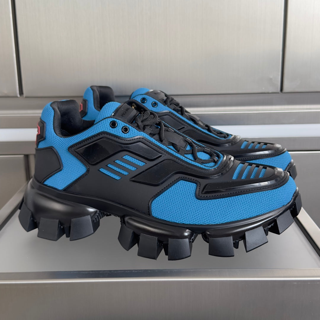 Blue and black unisex Prada sneakers with chunky tread and lace-up design