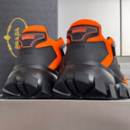 Unisex chunky sneakers close-up at heel, orange and black with high lug tread