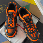 Unisex chunky sneakers close-up, black laces and orange trim with molded side logo