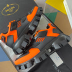 Unisex chunky sneakers close-up, orange and black upper with chunky lug tread sole