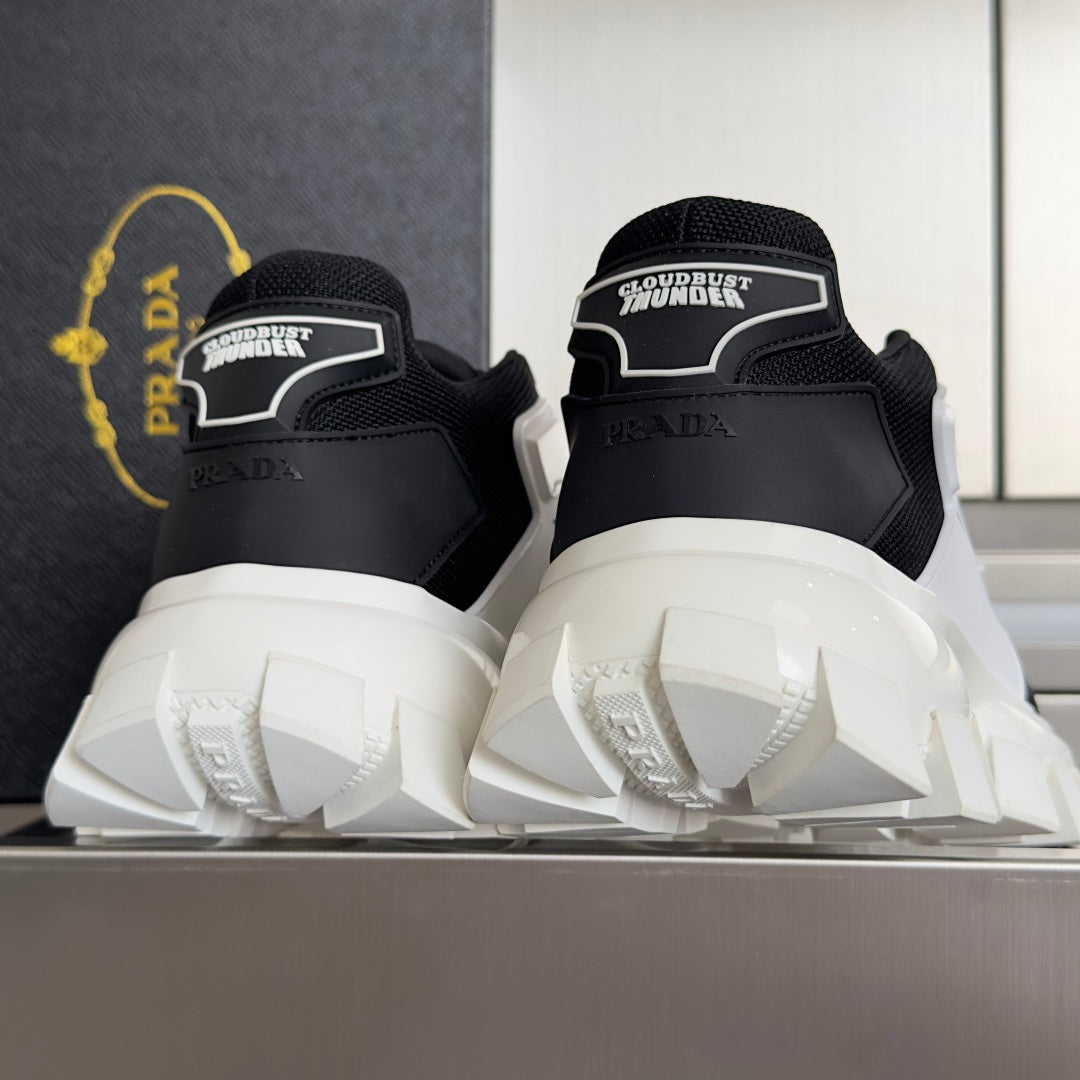 Black Prada sneakers with heel text details and white treaded lug outsole