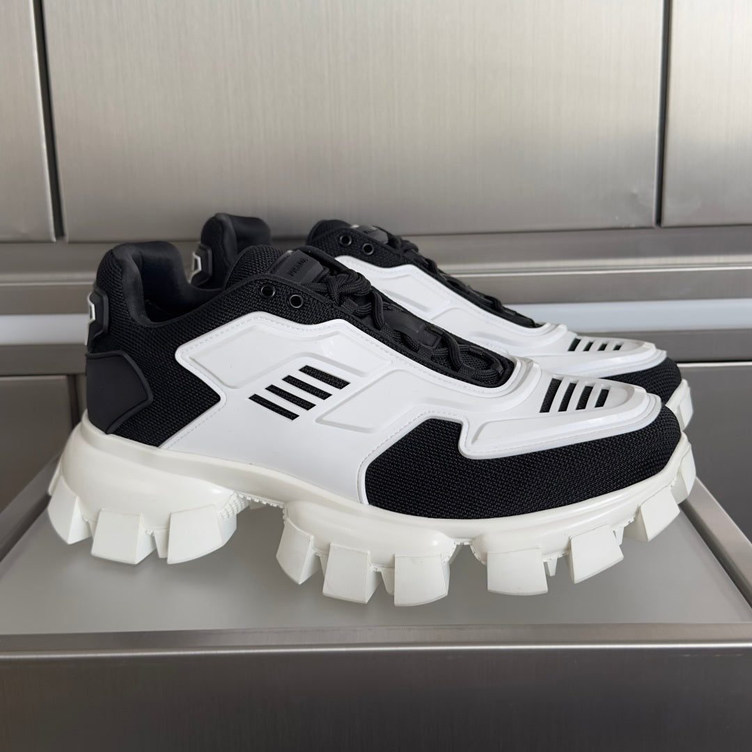 Black and white chunky sneakers with white panel and ribbed stripes, thick lug sole