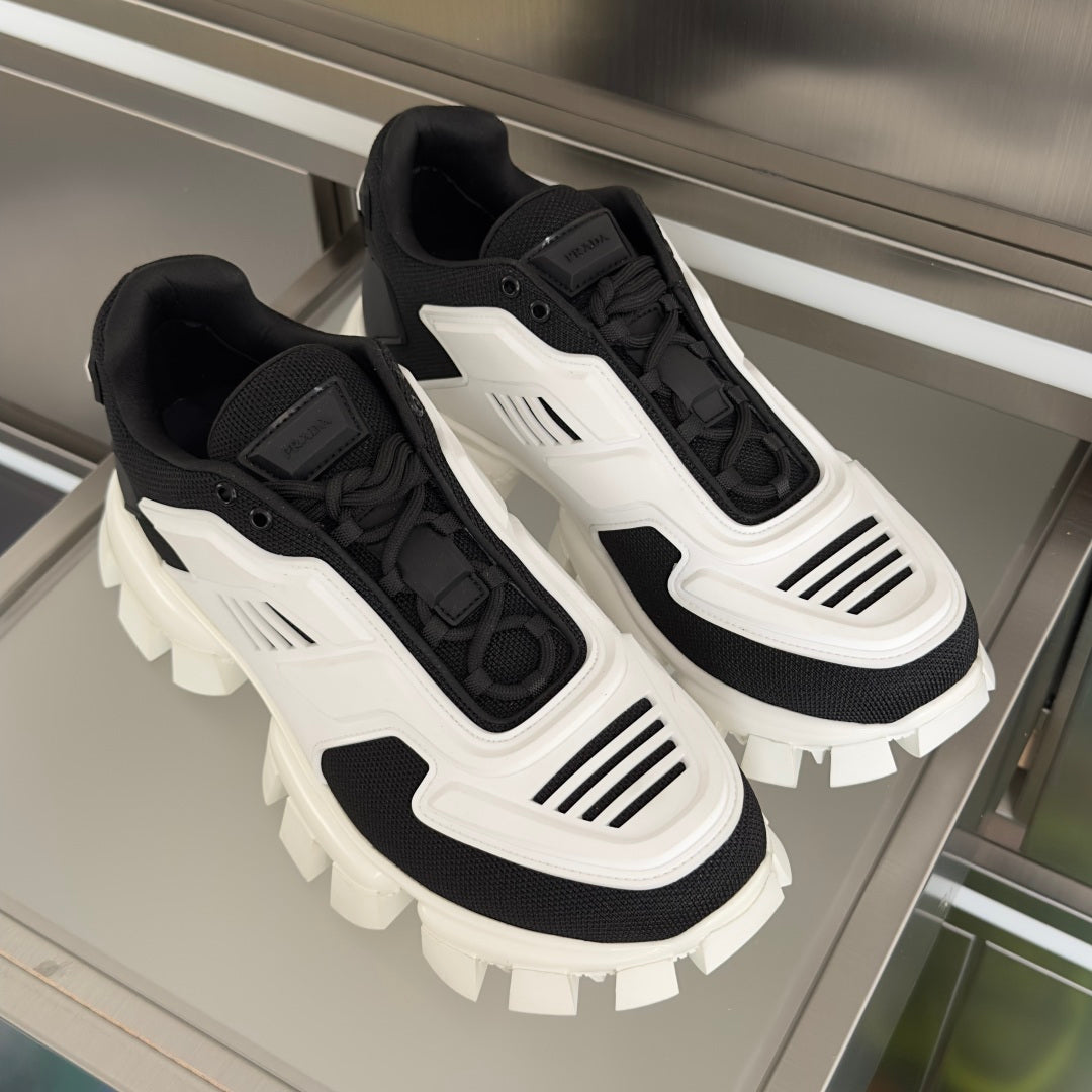 Pair of black and white chunky sneakers with white logo stripes and thick lug outsole