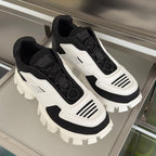 Prada unisex sneakers pair view, black-and-white uppers with thick sculpted tread sole