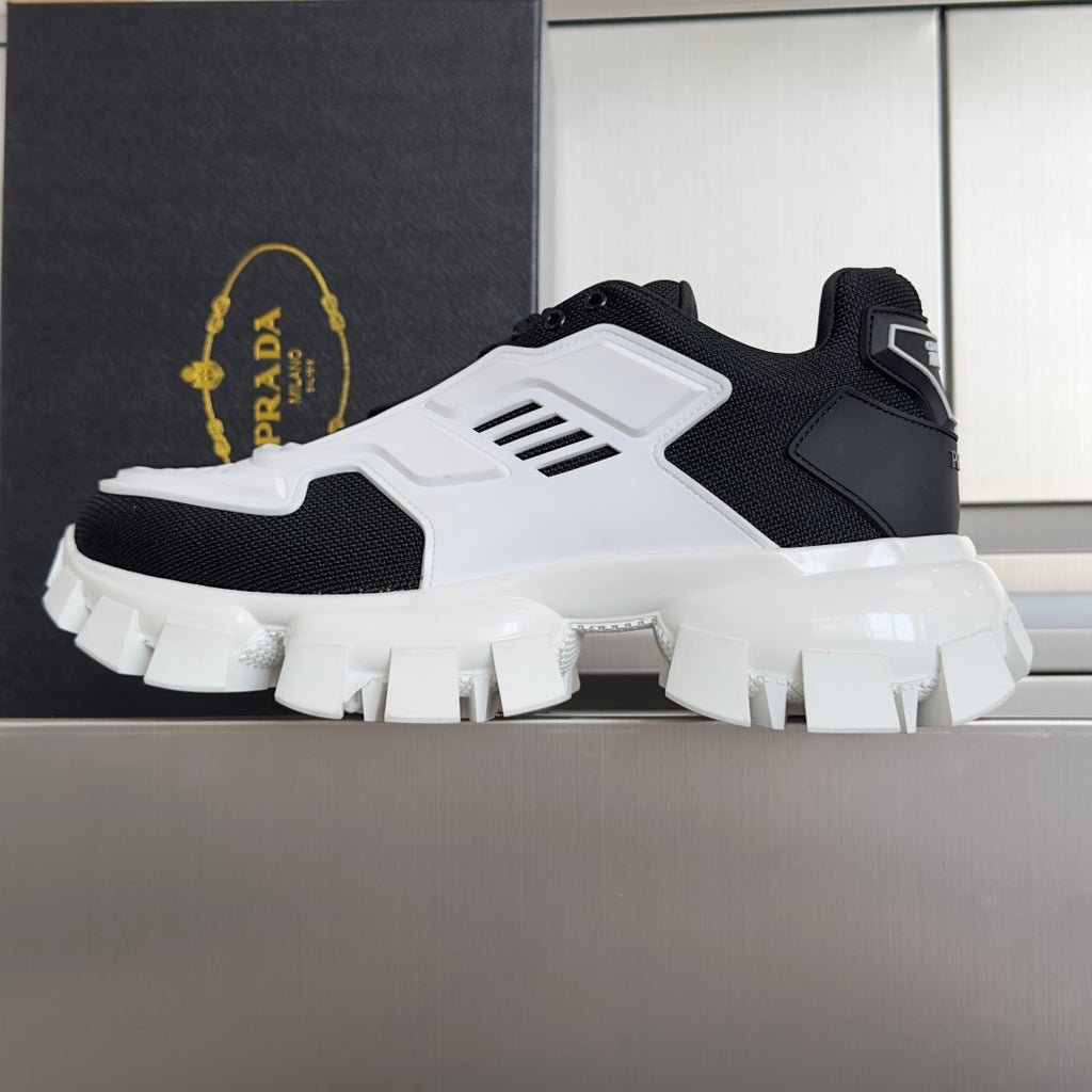 Prada unisex sneakers, black mesh uppers with white side panels and rugged tread sole