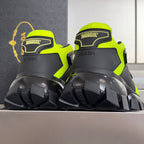 Neon green and black Prada sneakers, rear branding and deep tread outsole