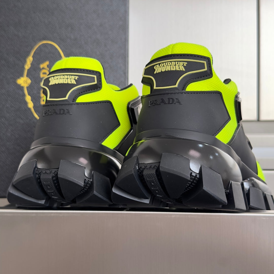 Neon green and black Prada sneakers, rear branding and deep tread outsole