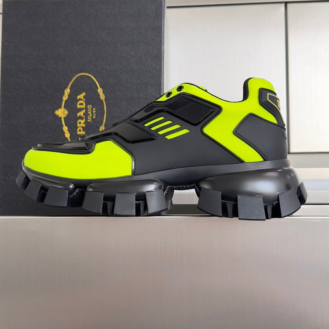 Prada unisex sneakers side view in neon green and black with thick tread sole