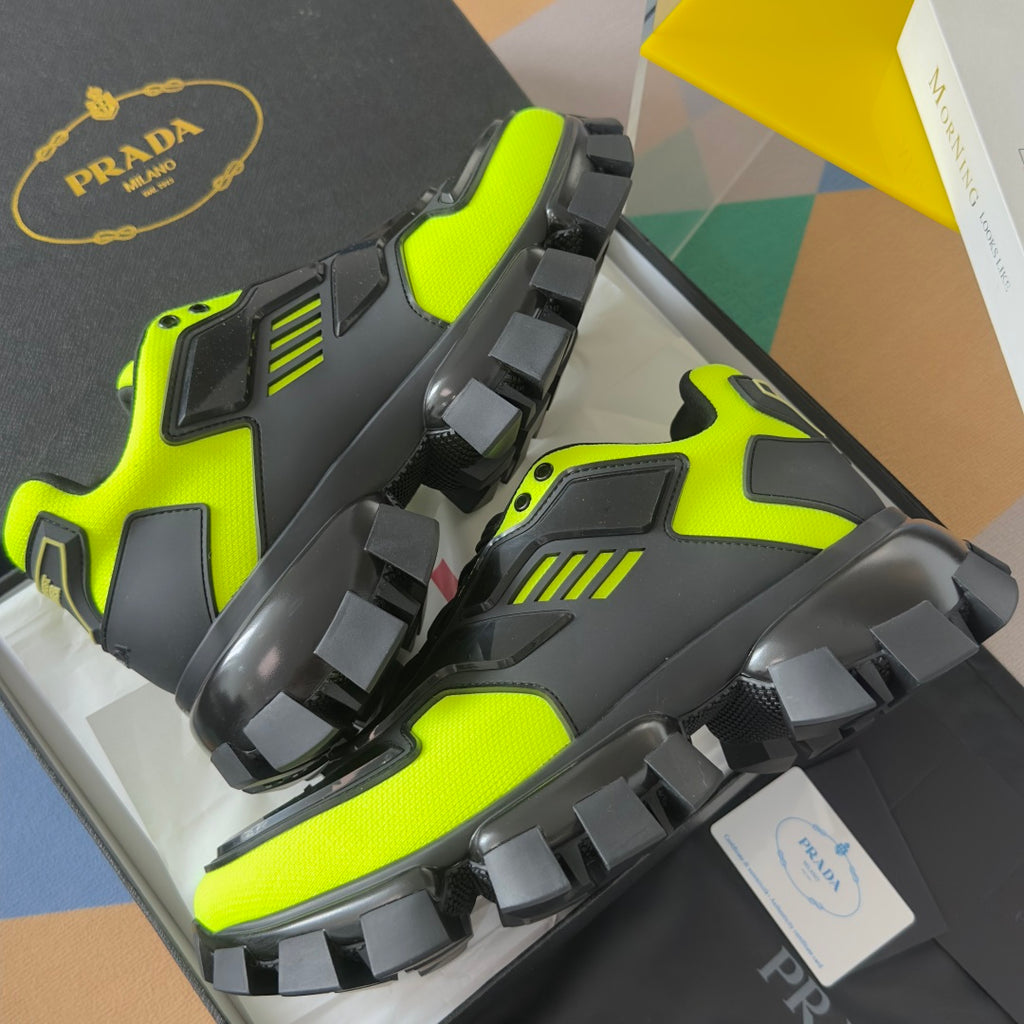 Prada unisex sneakers angled view, neon green and black with protective toe panels