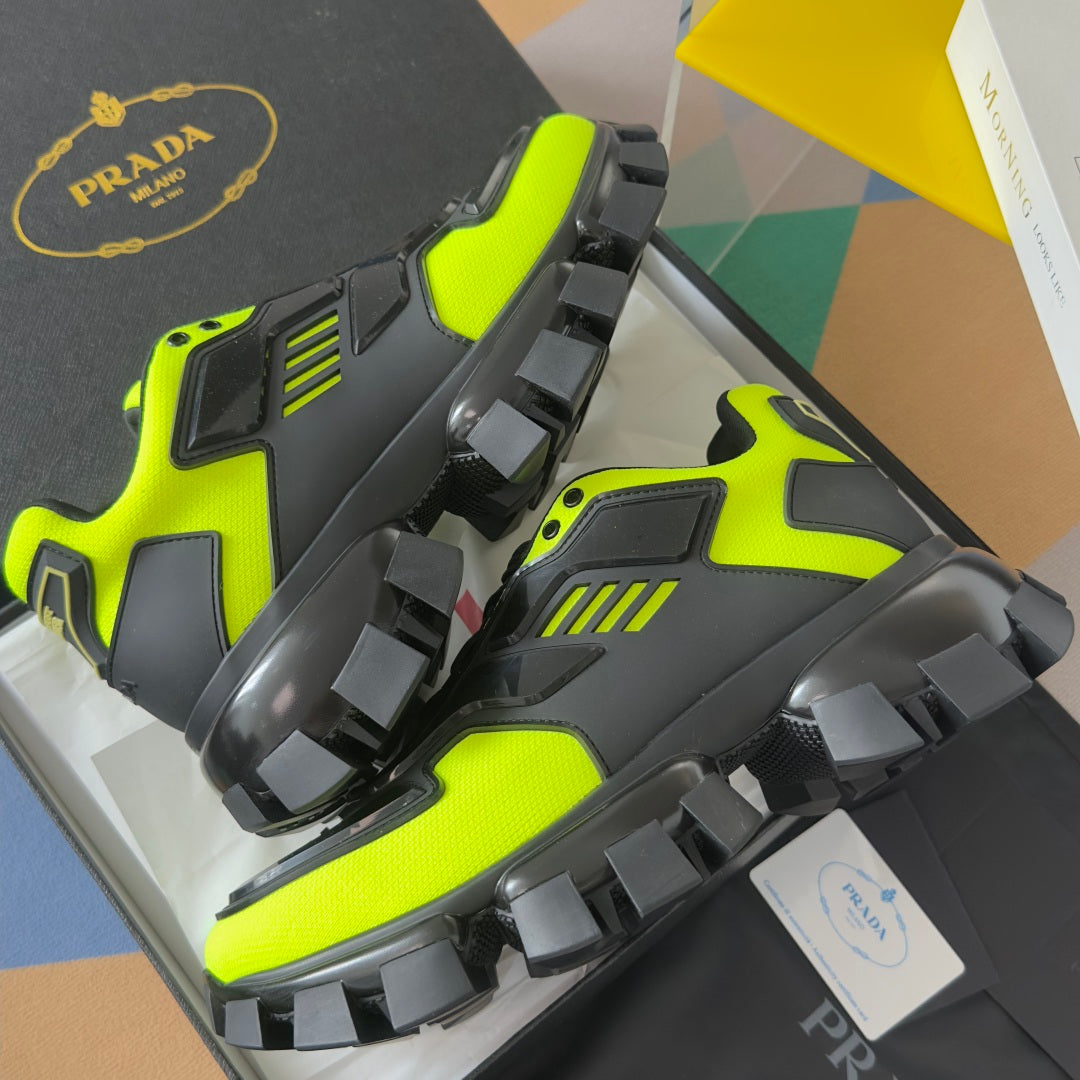 Prada unisex sneakers angled view, neon green and black with protective toe panels